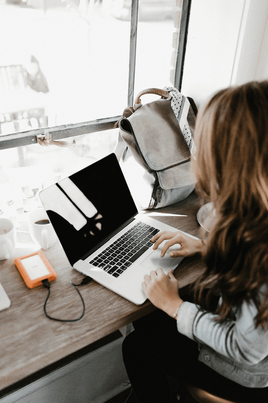 Woman typing on a laptop